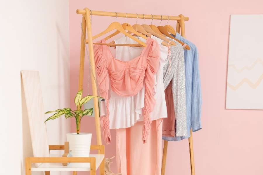 A clothing rack featuring stylish summer outfits that prioritize summer breathability.
